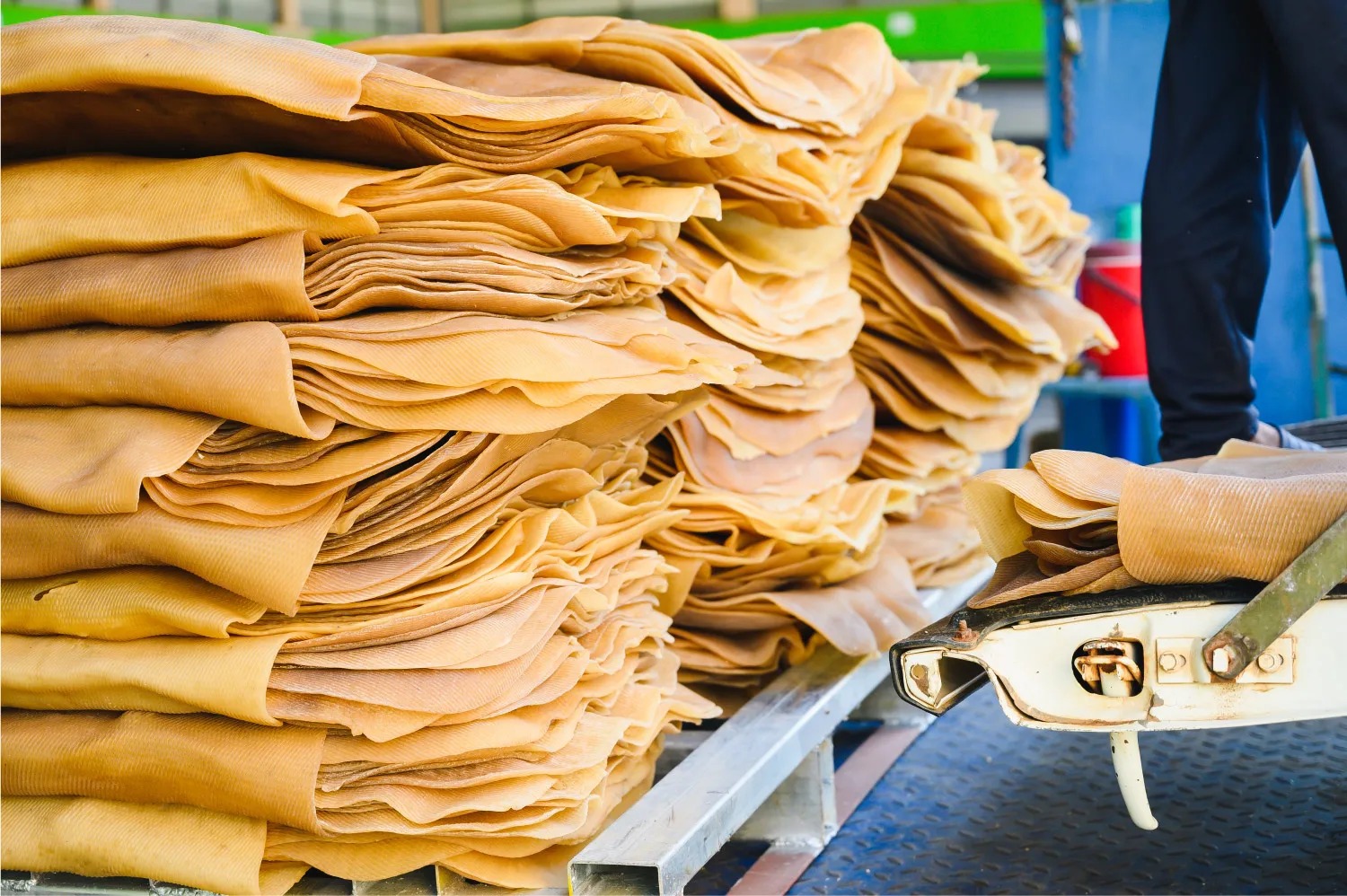 Ribbed smoked latex sheets stacked during industrial rubber processing